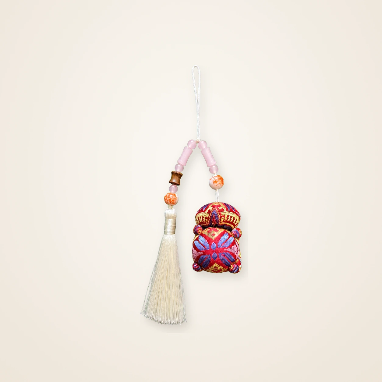 Front view of brocade bag charm Long Tassel · Crimson Butterfly Blossom, handwoven brocade woven in the butterfly-and-blossom motif