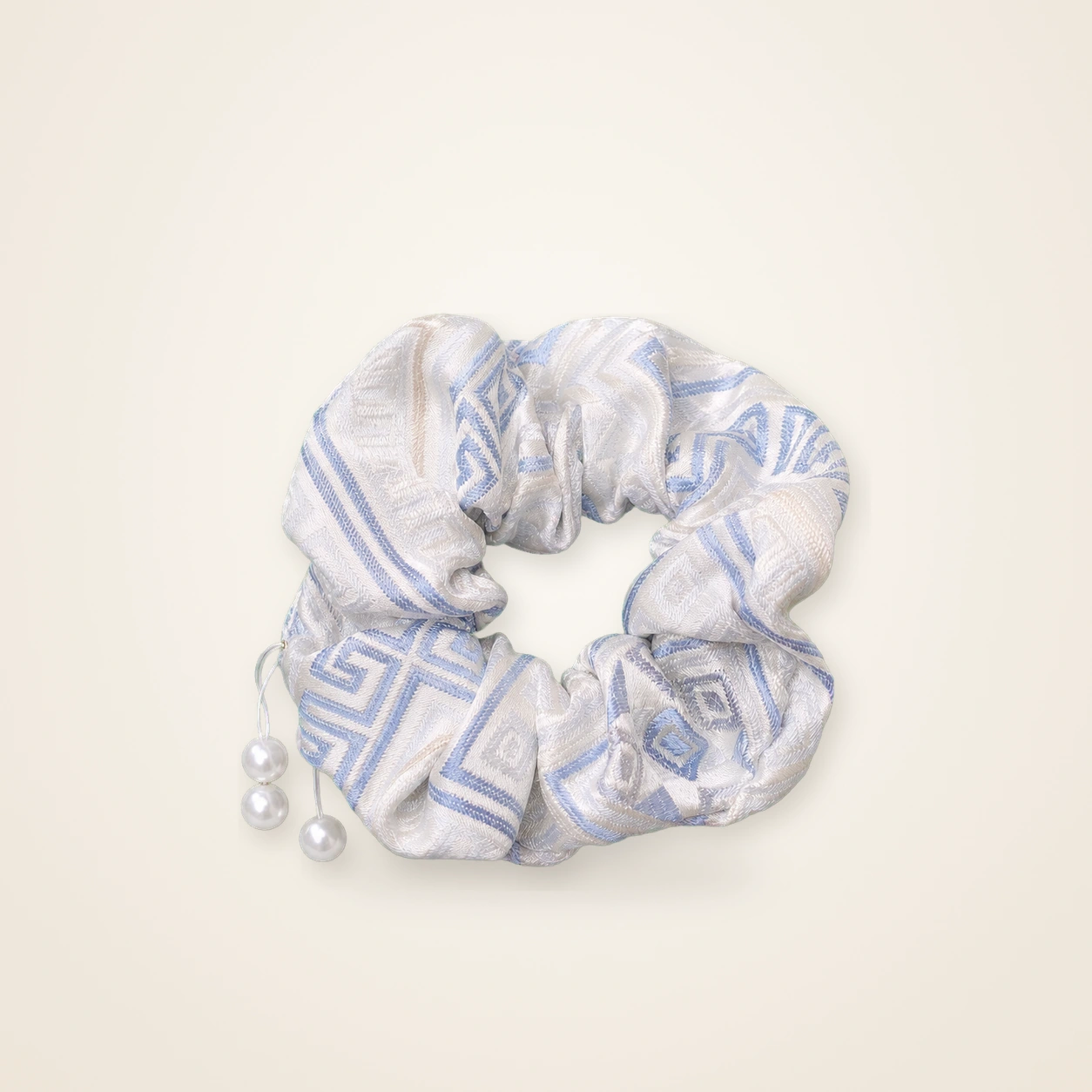 Front view of brocade scrunchie Brocade Halo · Pale Blue Geometry, handwoven brocade woven in the highland geometric motif