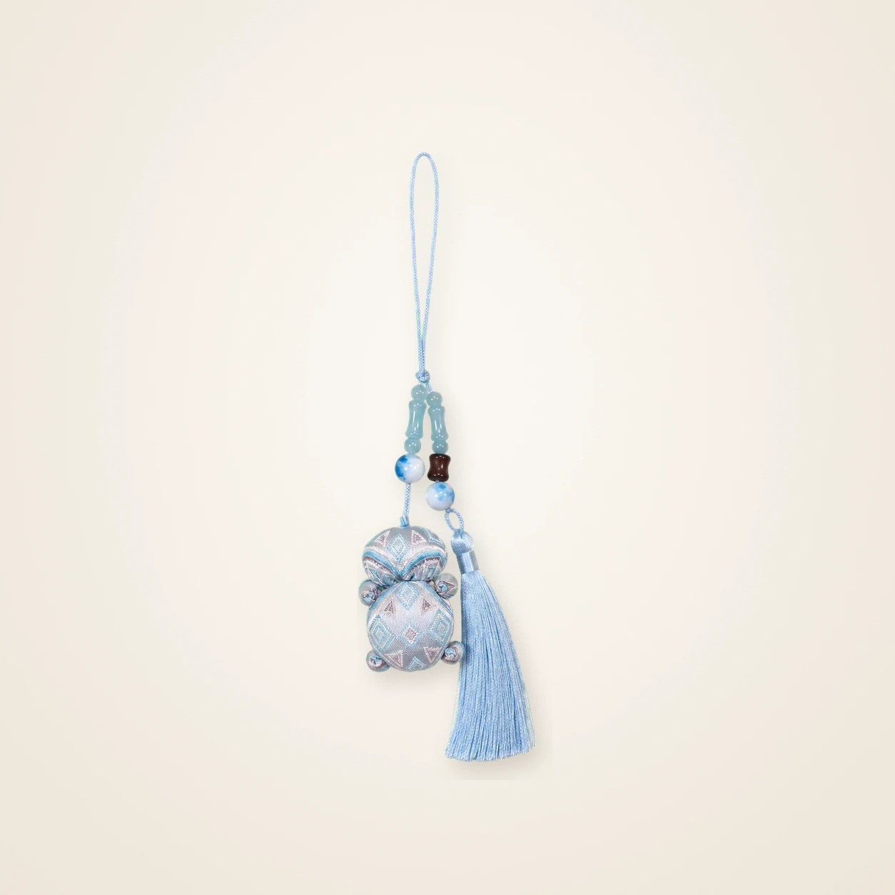 Front view of brocade bag charm Brocade Tassel · Mist Blue, handwoven brocade made as a brocade tassel charm