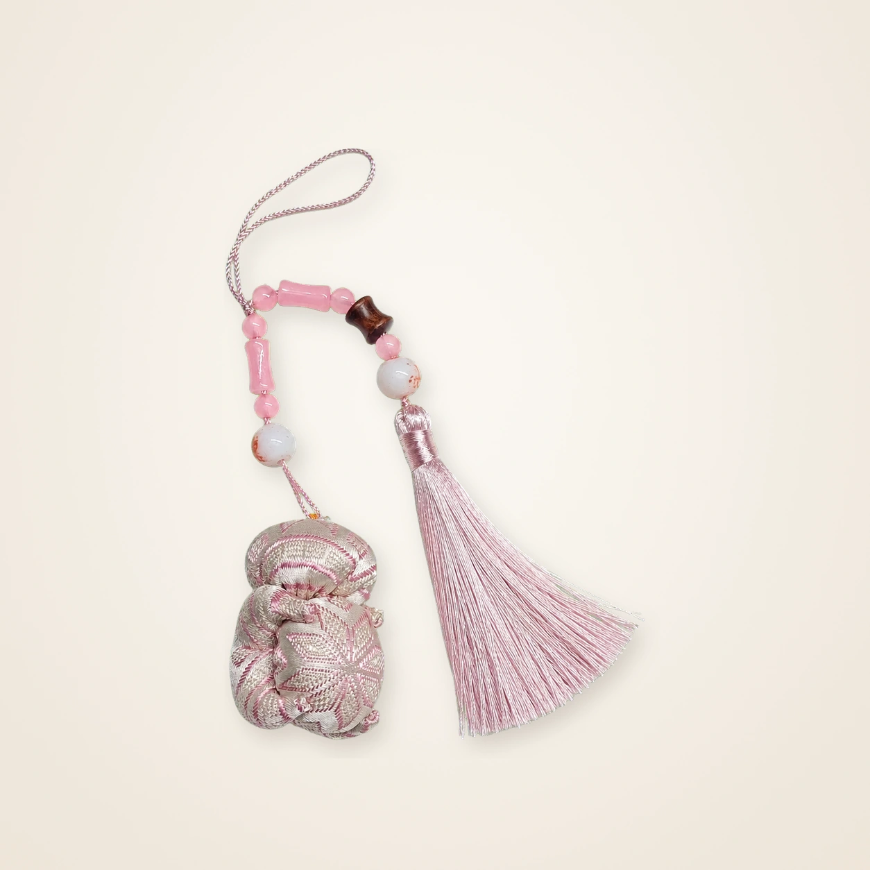 Front view of brocade bag charm Brocade Tassel · Blush Butterfly Pendant, handwoven brocade woven in the butterfly-and-blossom motif