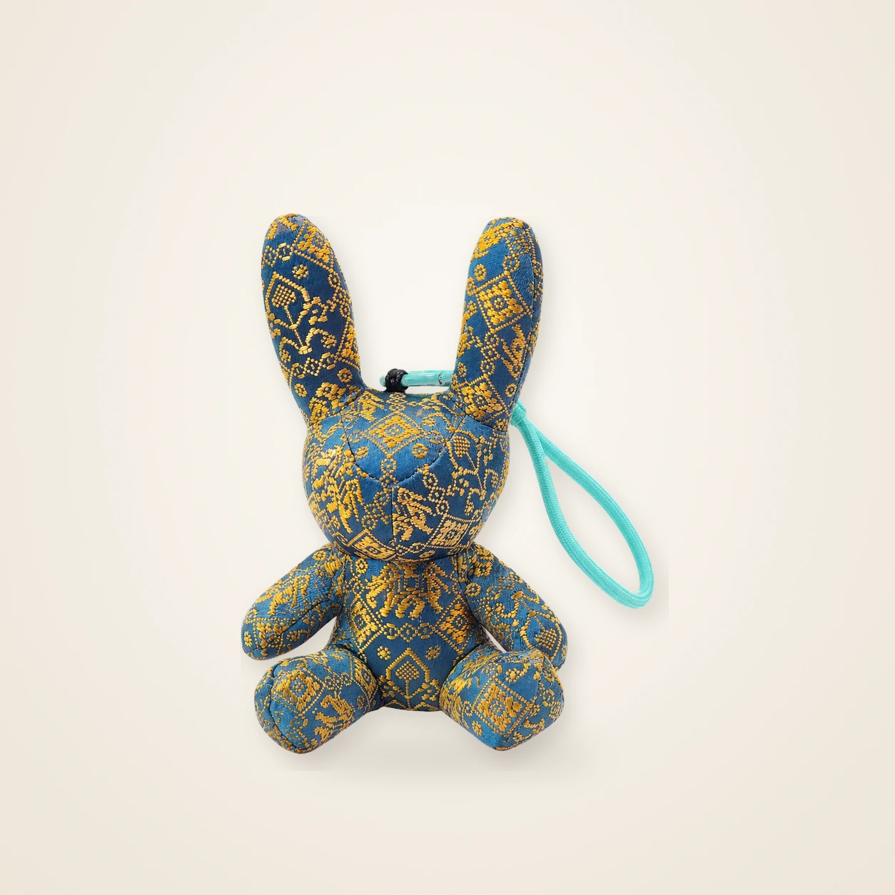 Front view of handmade textile figure Brocade Rabbit · Golden Sheaf, handwoven brocade made as a brocade rabbit