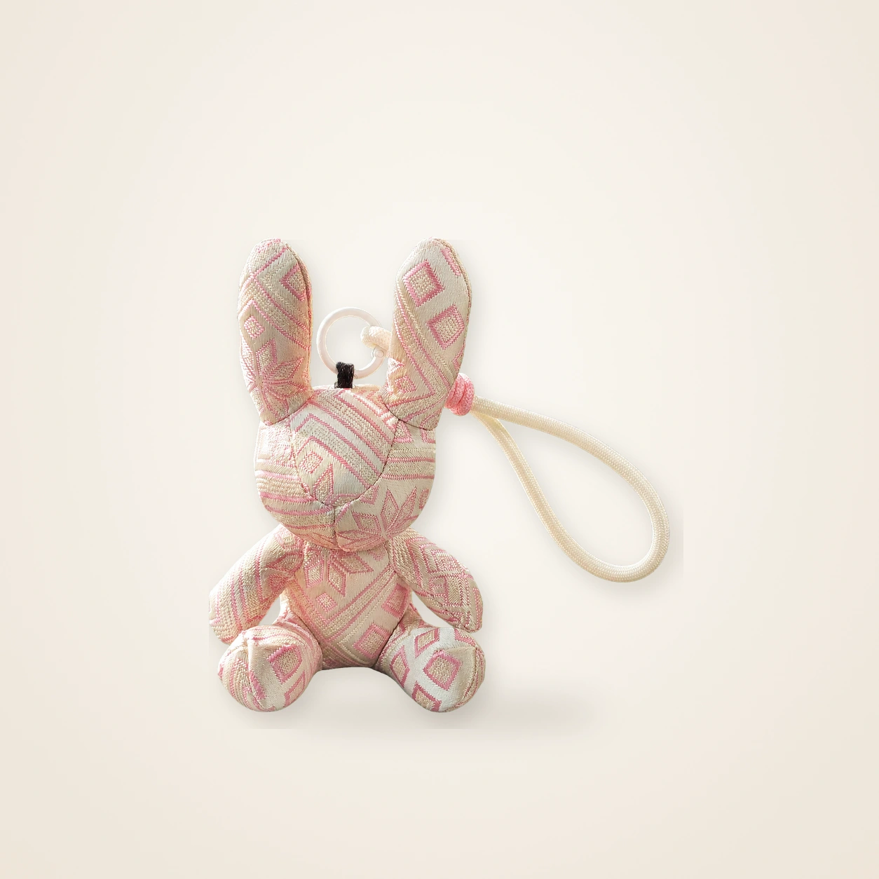 Front view of handmade textile figure Brocade Rabbit · Silken Blush, handwoven brocade made as a brocade rabbit