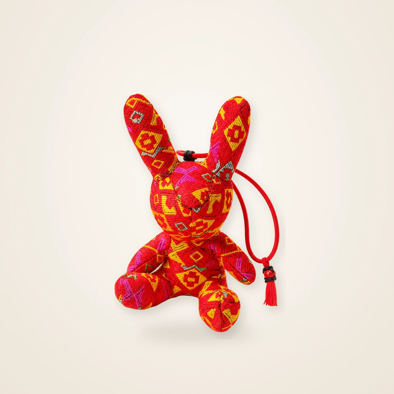 Front view of handmade textile figure Brocade Rabbit · Cinnabar, handwoven brocade made as a brocade rabbit