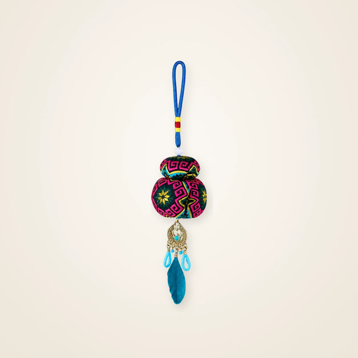 Front view of brocade bag charm Guardian Blessing · Jade & Blush Meander, handwoven brocade woven in the huiwen meander motif