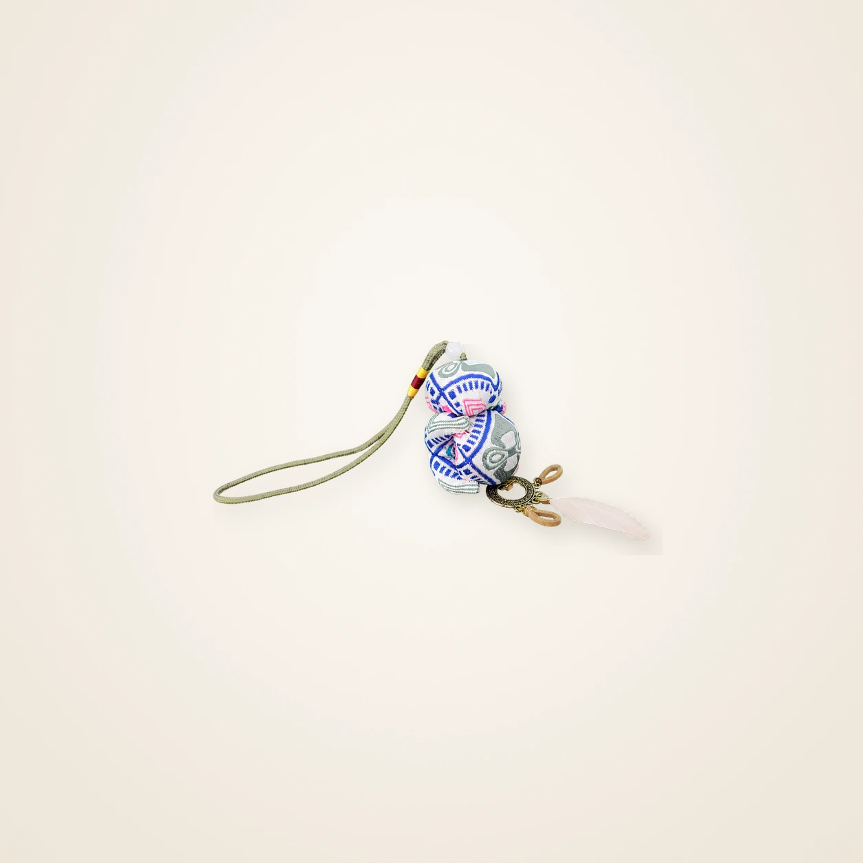 Front view of brocade bag charm Guardian Blessing · Emerald Tujia Brocade Motif, handwoven brocade woven in the xilankapu coverlet motif