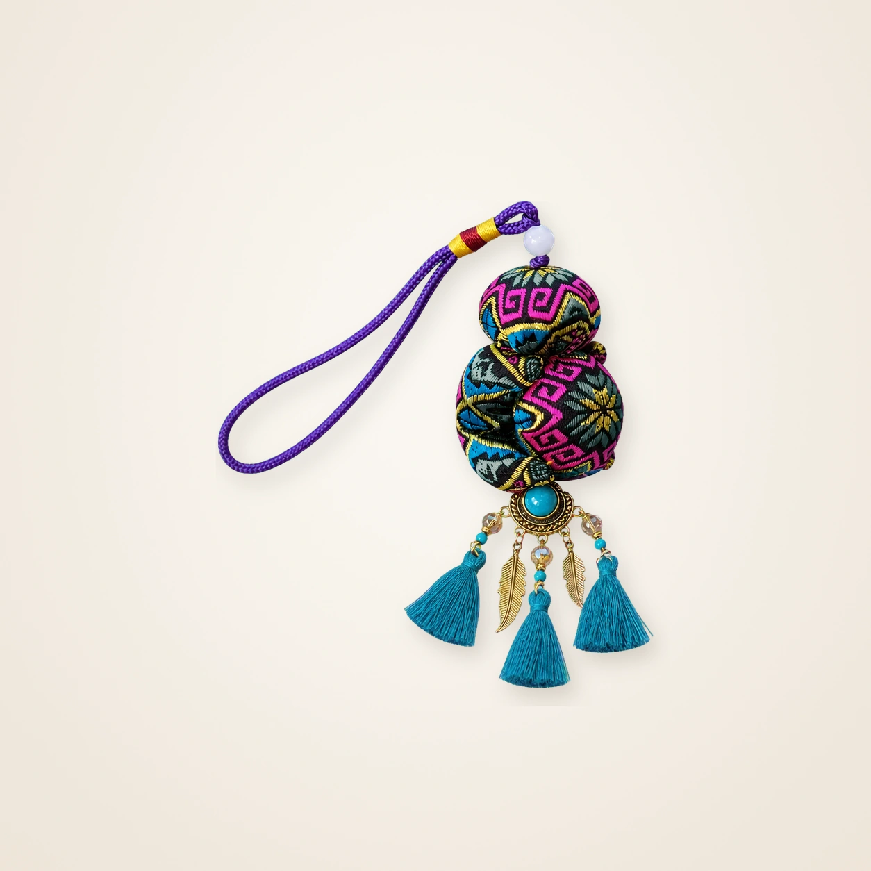 Front view of brocade bag charm Guardian Blessing · Violet & Jade Octagonal Blossom, handwoven brocade woven in the highland geometric motif