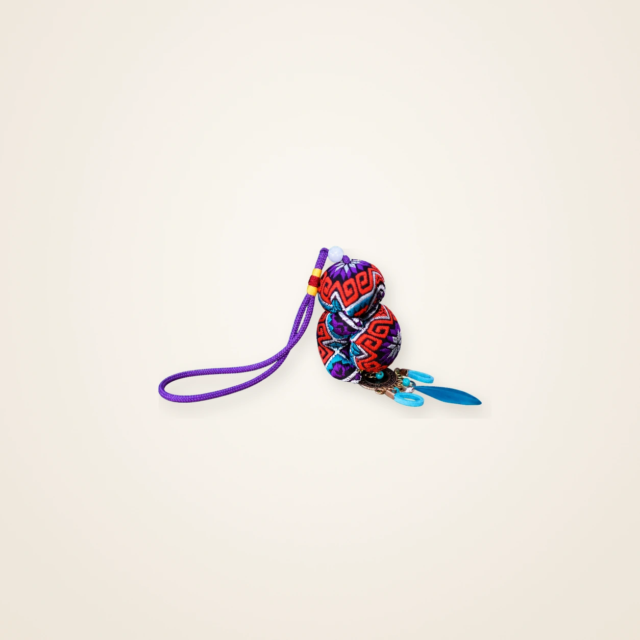 Front view of brocade bag charm Guardian Blessing · Amethyst Octagonal Blossom, handwoven brocade woven in the highland geometric motif