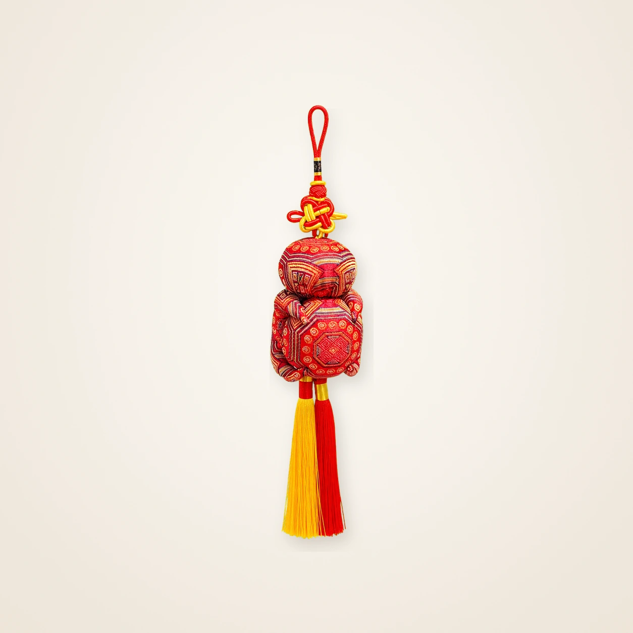 Front view of brocade bag charm Grand Guardian · Vermilion, handwoven brocade made as a momie guardian sachet