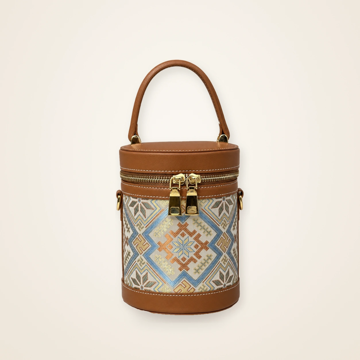Front view of woven bucket bag Four Swallows · Golden Brown, handwoven brocade woven in the swallows-greeting-the-blossom motif