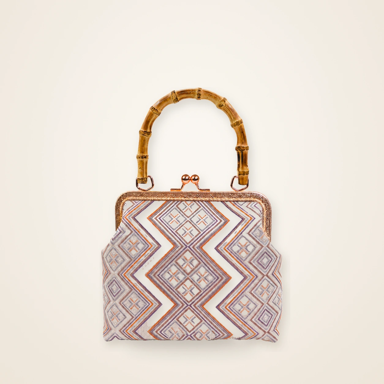 Front view of woven mini frame bag Miao Brocade · Blush Pink, handwoven brocade woven in the highland geometric motif