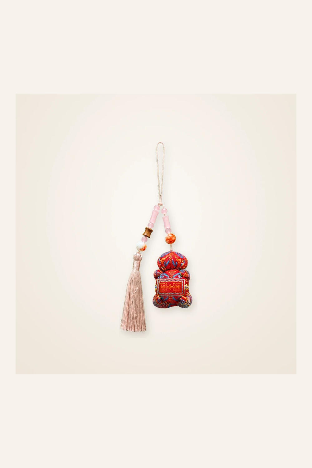 Front view of brocade bag charm Long Tassel · Eternal Bloom, handwoven brocade woven in the longevity-blossom motif