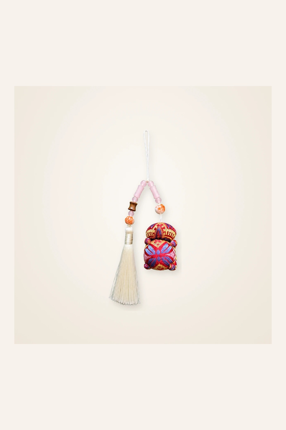 Front view of brocade bag charm Long Tassel · Crimson Butterfly Blossom, handwoven brocade woven in the butterfly-and-blossom motif