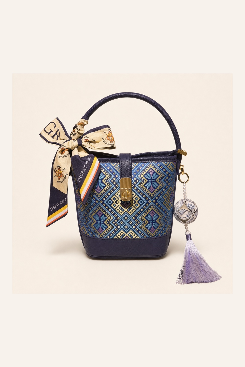 Front view of woven bucket bag Butterfly Reverie · Midnight Blue, handwoven brocade woven in the butterfly-and-blossom motif