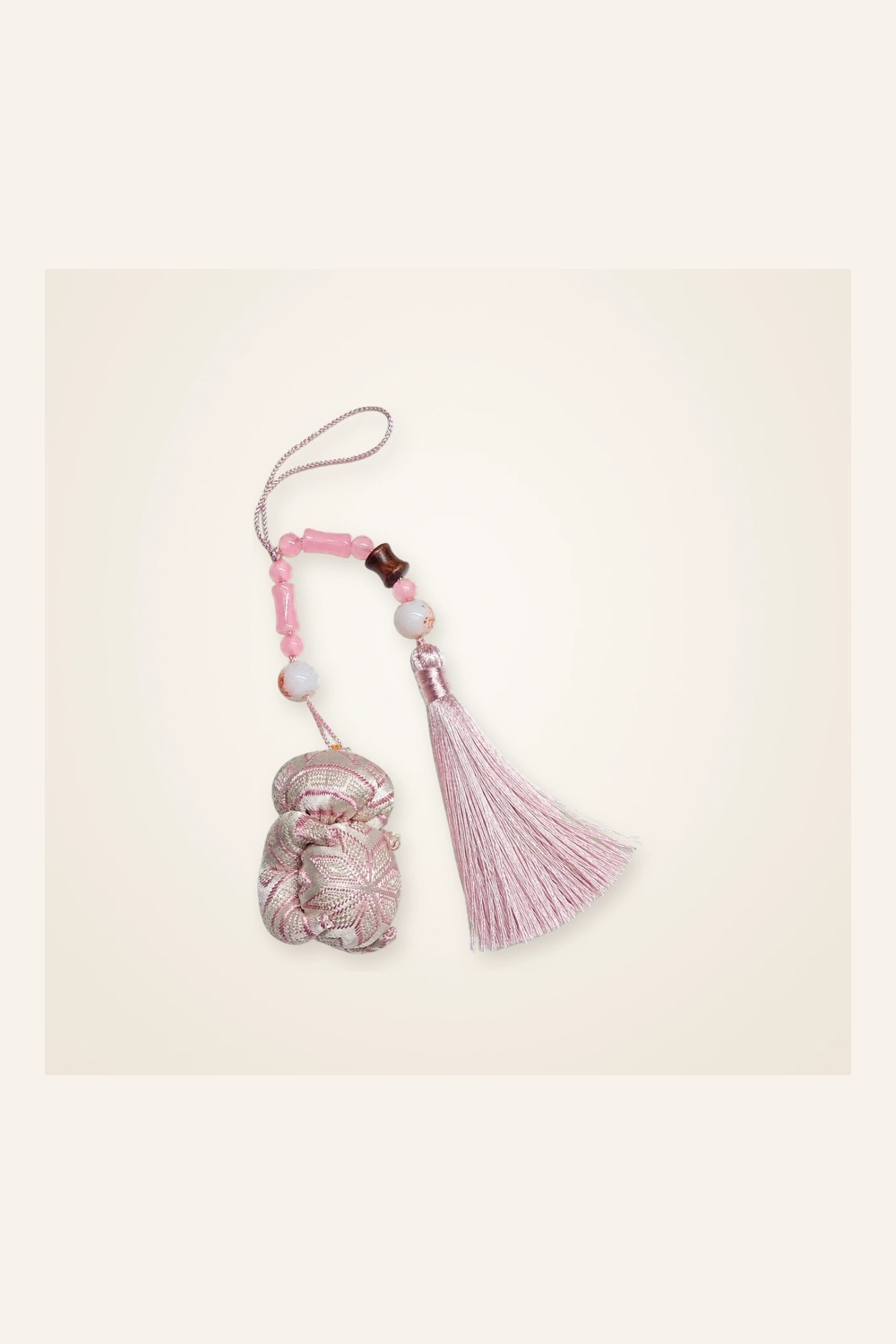 Front view of brocade bag charm Brocade Tassel · Blush Butterfly Pendant, handwoven brocade woven in the butterfly-and-blossom motif