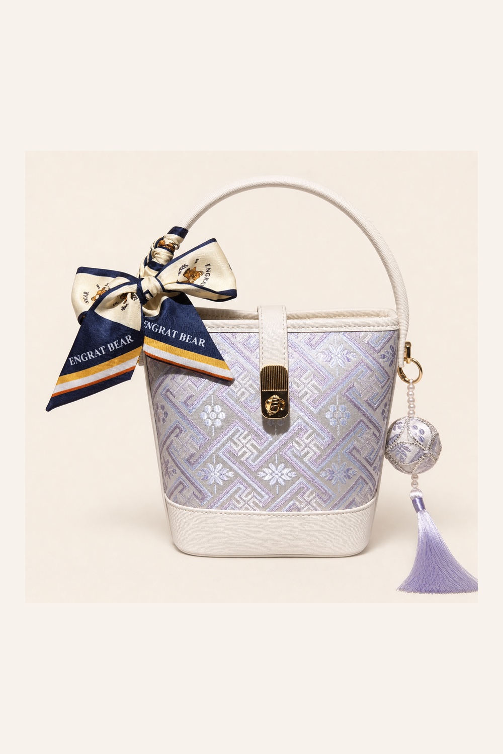 Front view of woven bucket bag Everlasting Fortune · Moon White, handwoven brocade woven in the wanji everlasting-fortune motif