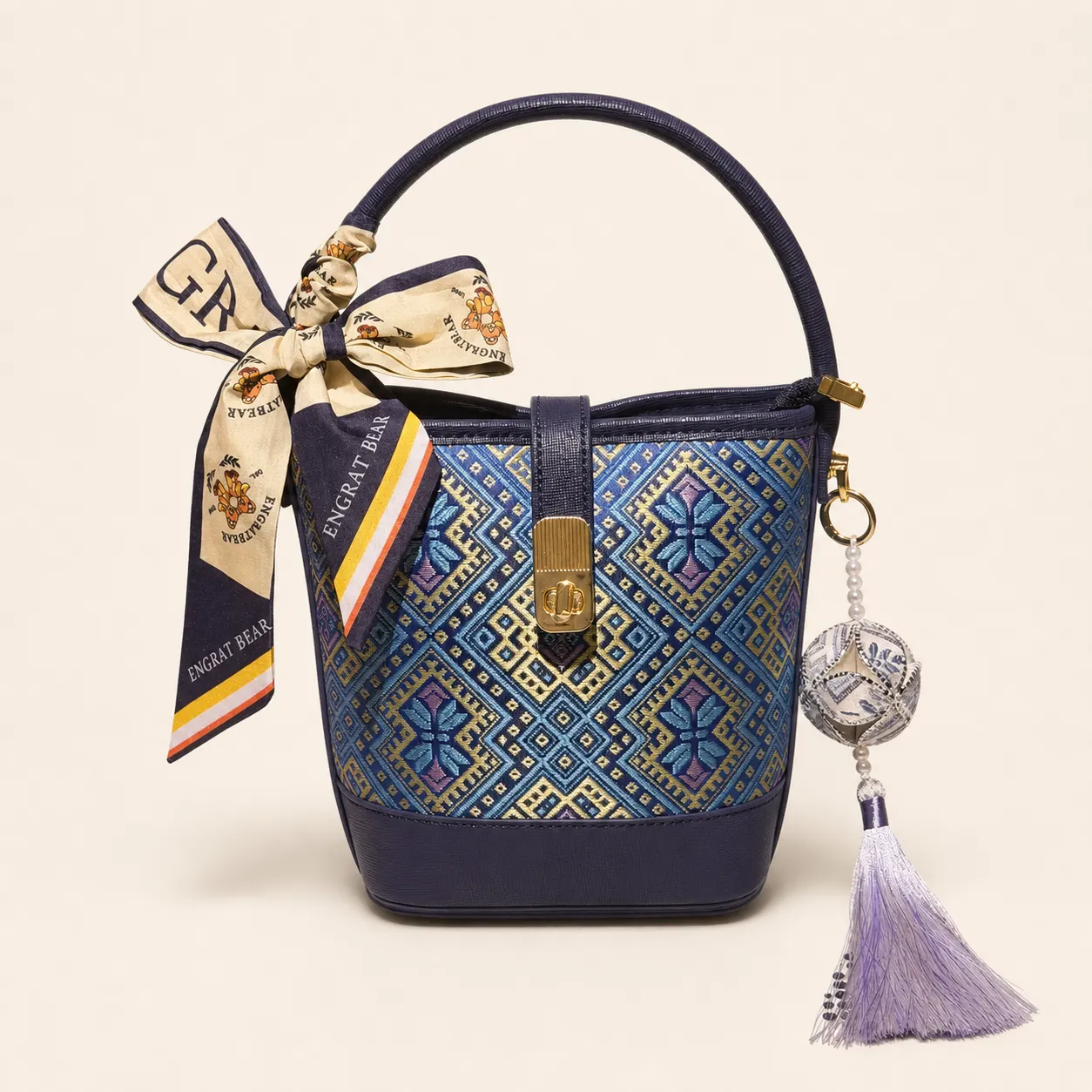 Front view of woven bucket bag Butterfly Reverie · Midnight Blue, handwoven brocade woven in the butterfly-and-blossom motif