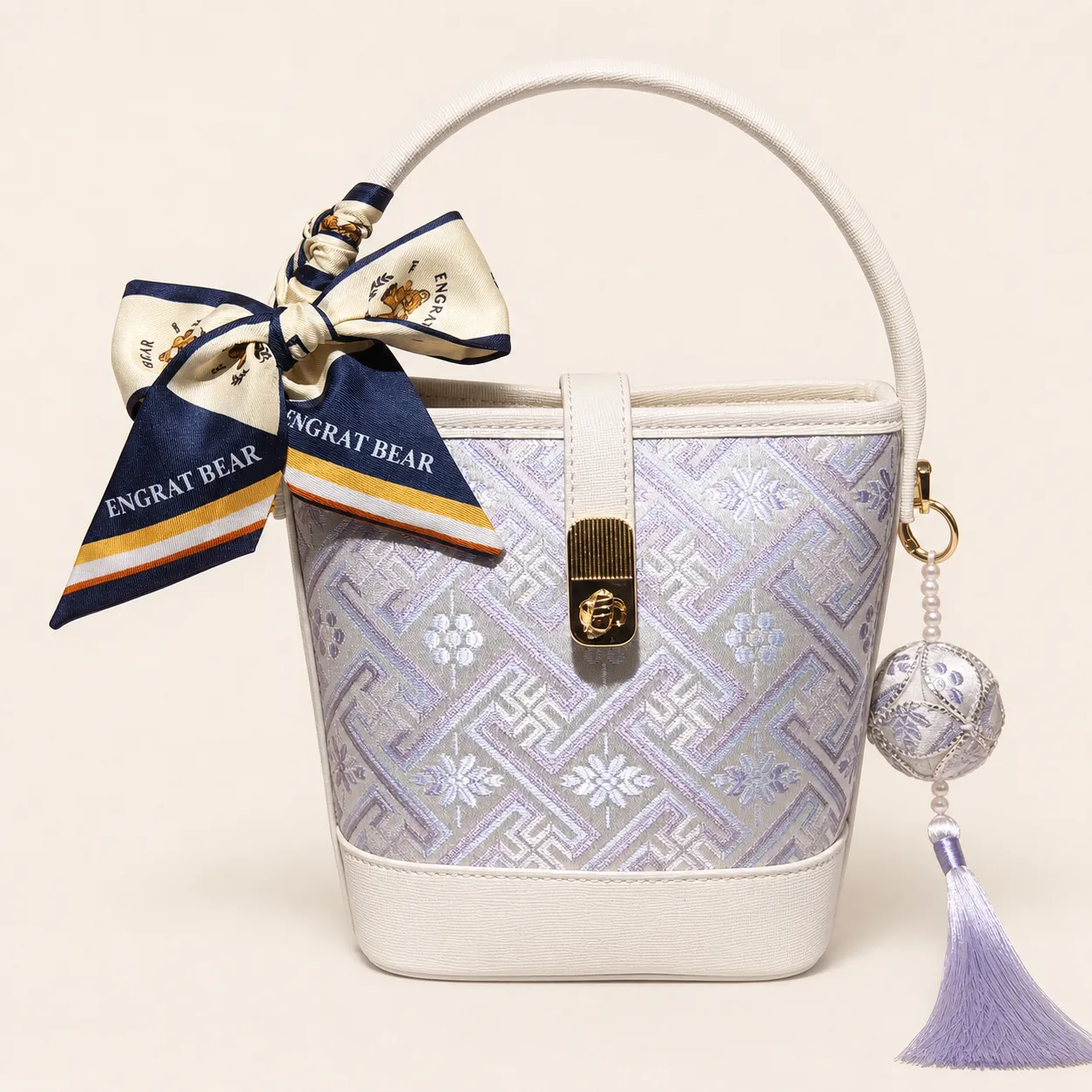 Front view of woven bucket bag Everlasting Fortune · Moon White, handwoven brocade woven in the wanji everlasting-fortune motif